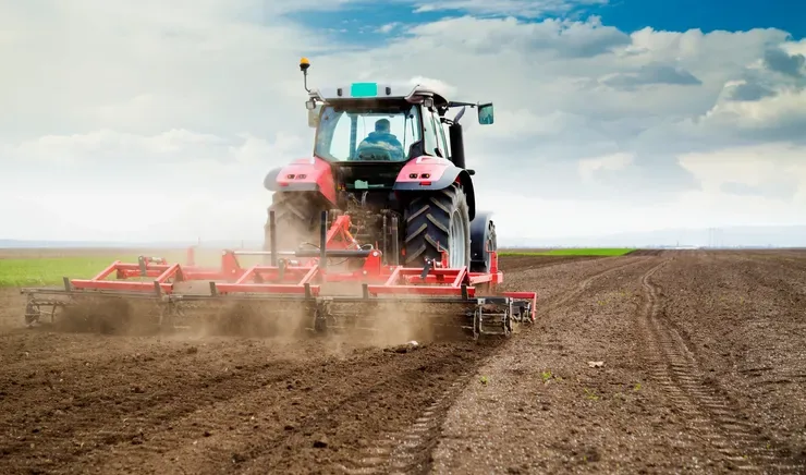 A tractor cultivating an arable field on the family farm